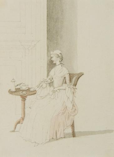 {'en': 'young lady seated at a table taking tea'}